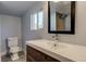 Modern bathroom featuring a vanity sink with chrome faucet and visible commode and window at 915 N Irving St, Denver, CO 80204