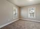 Clean and cozy bedroom with neutral carpet, fresh paint, and natural light at 915 N Irving St, Denver, CO 80204