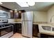 Updated kitchen with stainless steel appliances, granite countertops, and wood-look floors at 915 N Irving St, Denver, CO 80204