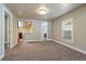 Open-concept living space with views into the kitchen and bathroom, featuring carpet and fresh paint at 915 N Irving St, Denver, CO 80204