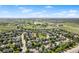 Aerial view of the neighborhood showing open green space, mature trees, and low-traffic, safe residential streets at 14794 Vine St, Thornton, CO 80602