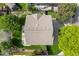 Aerial view showcases backyard with green grass, mature trees, a concrete patio and well-maintained landscaping at 14794 Vine St, Thornton, CO 80602