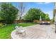 Expansive backyard featuring a stamped concrete patio, outdoor seating, and lush greenery at 14794 Vine St, Thornton, CO 80602