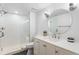 Bathroom featuring a walk-in shower with glass door and round mirror at 14794 Vine St, Thornton, CO 80602