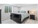Bedroom with a black sleigh bed and large window at 14794 Vine St, Thornton, CO 80602