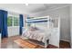 Cozy bedroom featuring a bunk bed and hardwood floors at 14794 Vine St, Thornton, CO 80602