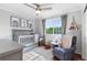 A well-lit Bedroom featuring a crib, recliner, and charming decor at 14794 Vine St, Thornton, CO 80602