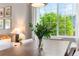 Bright dining room features a large window, modern light fixture, and seating for six at 14794 Vine St, Thornton, CO 80602