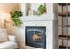 Close-up of a cozy fireplace with a decorative mantle and shelving, creating a warm and inviting atmosphere at 14794 Vine St, Thornton, CO 80602