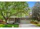 Charming two-story home featuring a stone facade, covered porch, and well-maintained front lawn and a two car garage at 14794 Vine St, Thornton, CO 80602