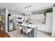Modern kitchen features stainless steel appliances, quartz countertops, island with bar seating, and pendant lighting at 14794 Vine St, Thornton, CO 80602