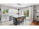 Modern kitchen features stainless steel appliances, island with bar seating, and bright, white subway tile backsplash at 14794 Vine St, Thornton, CO 80602