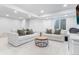 Basement living room featuring white couches, a circular coffee table and carpet at 14794 Vine St, Thornton, CO 80602