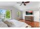 Bright main bedroom featuring large windows, hardwood floors, and a ceiling fan at 14794 Vine St, Thornton, CO 80602