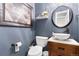 Stylish powder room featuring a round mirror, vessel sink, and modern fixtures at 14794 Vine St, Thornton, CO 80602