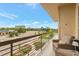 Balcony with furniture overlooking the street, green grass, and distant buildings at 10111 Inverness Main St # 301, Englewood, CO 80112