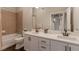 Bright bathroom with double sink vanity, modern fixtures, and shower over tub at 10111 Inverness Main St # 301, Englewood, CO 80112