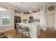 Contemporary kitchen featuring white cabinets, stainless appliances, hardwood floors, a kitchen island with pendant lighting at 10111 Inverness Main St # 301, Englewood, CO 80112