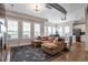 Open-concept living room, kitchen and dining area featuring hardwood floors, exposed ductwork, and many windows at 10111 Inverness Main St # 301, Englewood, CO 80112