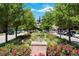 Charming street view with artful sculpture and lush greenery at 10111 Inverness Main St # 301, Englewood, CO 80112