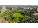 This aerial view overlooks a spacious green park and the city skyline at 221 S Garfield St # 213, Denver, CO 80209