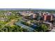 This aerial view showcases the property's proximity to tennis courts, trees, and cityscape at 221 S Garfield St # 213, Denver, CO 80209