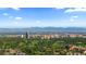 Expansive aerial view showcases the city skyline with a backdrop of majestic mountains at 221 S Garfield St # 213, Denver, CO 80209