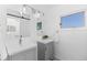 Bathroom with double sink vanity, sliding mirror, and modern lighting fixtures at 221 S Garfield St # 213, Denver, CO 80209