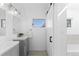 Bathroom with a sliding mirror, double sink vanity, and bright window at 221 S Garfield St # 213, Denver, CO 80209