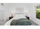 Inviting bedroom with natural light, stylish side tables, soft bedding and decorative botanical prints at 221 S Garfield St # 213, Denver, CO 80209