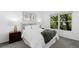 Bright bedroom featuring a large window, plush bedding, side tables, and botanical wall decor at 221 S Garfield St # 213, Denver, CO 80209