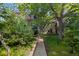 Attractive condo with a manicured lawn, mature trees and a sidewalk leading to the front door at 221 S Garfield St # 213, Denver, CO 80209