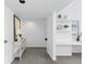 Hallway featuring built-in desk, shelving, neutral paint, and gray carpet leading up the stairs at 221 S Garfield St # 213, Denver, CO 80209