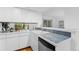 Bright kitchen with stainless steel appliances, white cabinetry, and tiled backsplash at 221 S Garfield St # 213, Denver, CO 80209