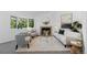 Bright living room with bay window, cozy fireplace, neutral decor, and plush rug at 221 S Garfield St # 213, Denver, CO 80209