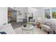 Bright living room with bay window, cozy fireplace, neutral decor, and plush rug at 221 S Garfield St # 213, Denver, CO 80209