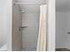 Shower featuring marble tile, overhead shower head and shower curtain at 221 S Garfield St # 213, Denver, CO 80209