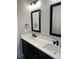 Modern bathroom featuring double sinks, black hardware and framed mirrors at 270 High Meadows Loop, Elizabeth, CO 80107