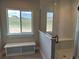 Well-lit shower room featuring a glass shower door and a built-in bench with a window at 270 High Meadows Loop, Elizabeth, CO 80107