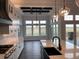 Bright kitchen with a large island, white cabinetry, a gas range, and exterior view at 270 High Meadows Loop, Elizabeth, CO 80107