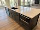 Kitchen island with quartz countertops, undermount microwave, and stainless steel dishwasher at 270 High Meadows Loop, Elizabeth, CO 80107