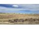 Wide shot of a grassy landscape underneath partly cloudy skies at 270 High Meadows Loop, Elizabeth, CO 80107