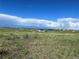 Open landscape and meadow with blue skies, scattered clouds, and a distant view of a house at 270 High Meadows Loop, Elizabeth, CO 80107