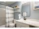 Stylish bathroom features modern fixtures, floating shelves, and a tub with a shower at 11033 E 28Th Pl, Denver, CO 80238