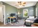 Stylish bedroom with a bed, desk, and natural light at 11033 E 28Th Pl, Denver, CO 80238
