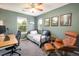 Green bedroom featuring a daybed, desk, and comfortable chair at 11033 E 28Th Pl, Denver, CO 80238