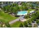 Aerial view of a community pool surrounded by mature trees and a playground in a well-maintained neighborhood at 11033 E 28Th Pl, Denver, CO 80238