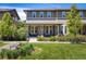 Charming townhome featuring a covered front porch and well-maintained lawn with lush landscaping at 11033 E 28Th Pl, Denver, CO 80238