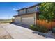 Two-story home featuring a two-car garage and spacious driveway at 11033 E 28Th Pl, Denver, CO 80238