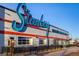 Exterior view of Stanley Marketplace featuring a modern facade, signage, and outdoor seating at 11033 E 28Th Pl, Denver, CO 80238
